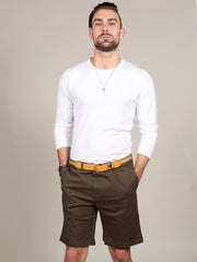 Model wearing white t-shirt with olive green chino shorts