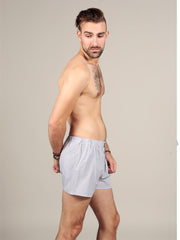 Side view of model wearing striped boxers in grey